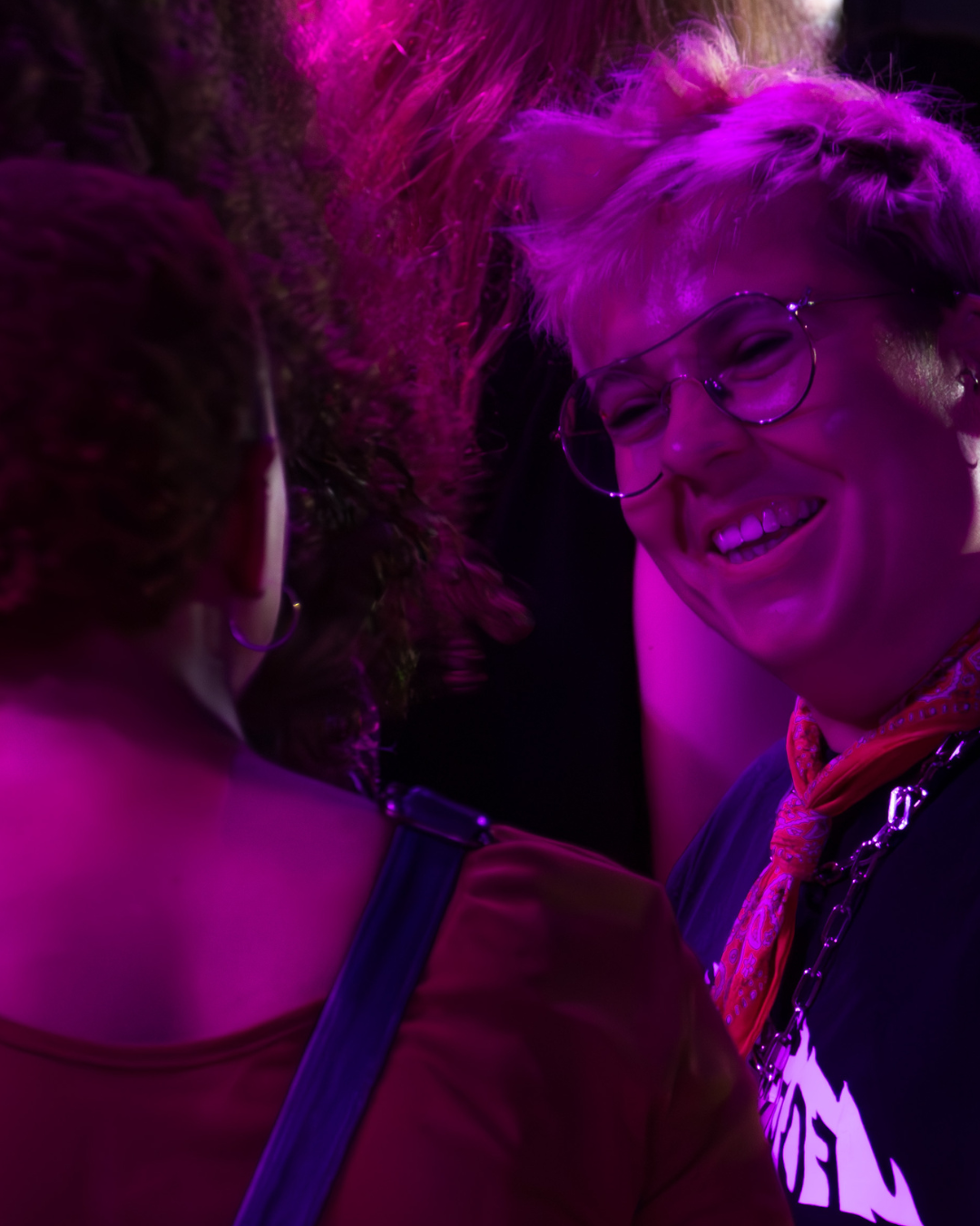 person smiling to another one in the club