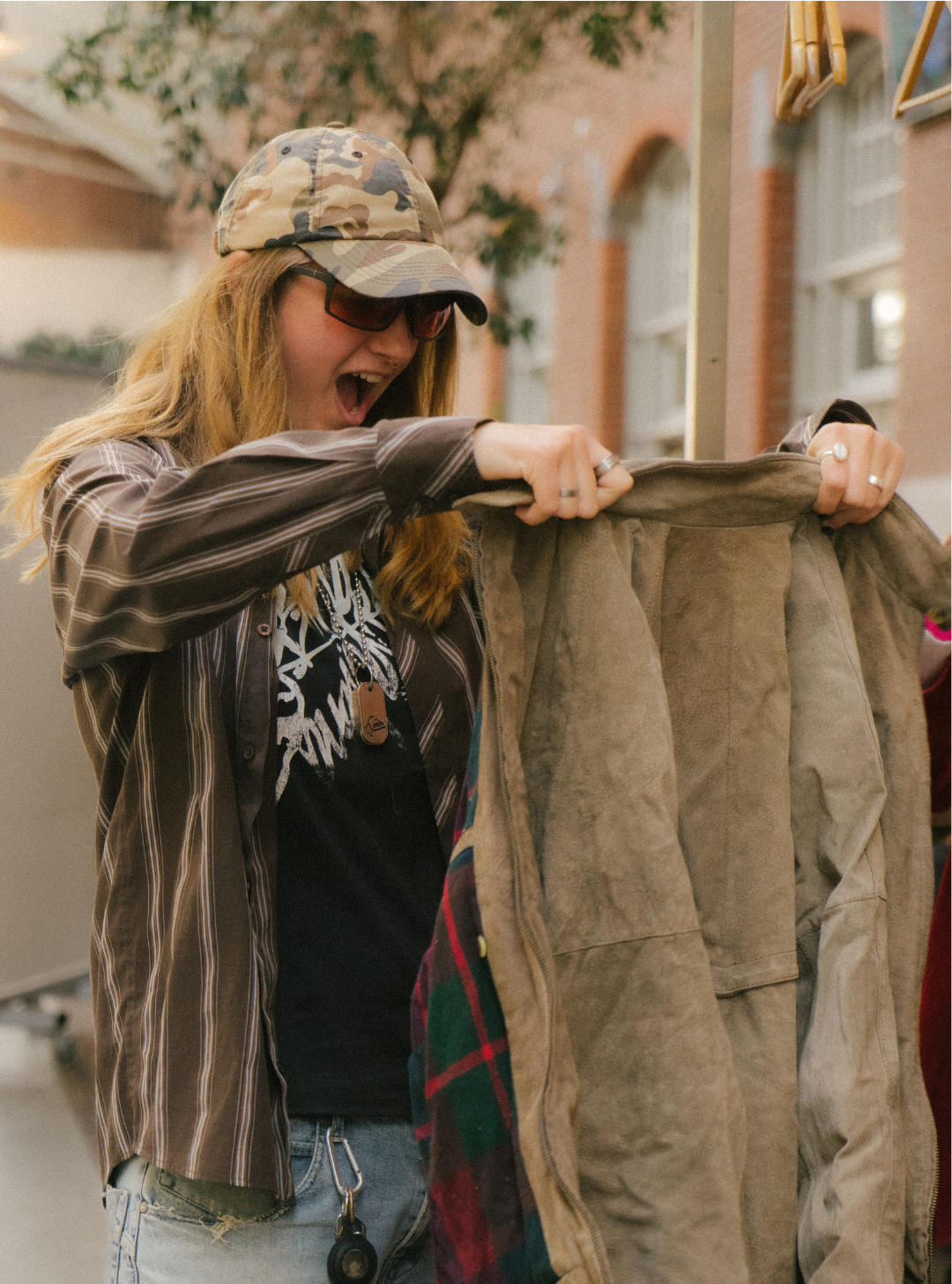 someone smiling picking a jacket