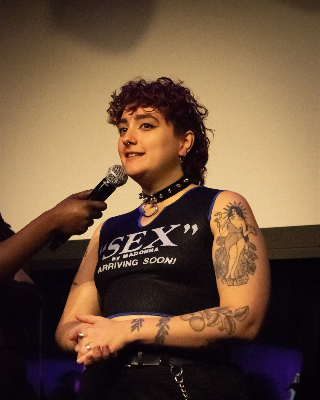 Melancholive speaking on a microphone